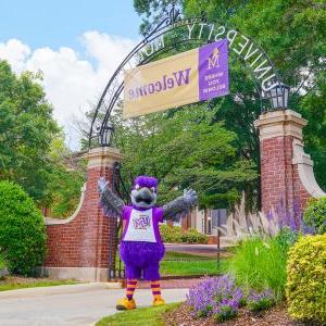 Freddie the Falcon in front of University of Montevallo campus gates.